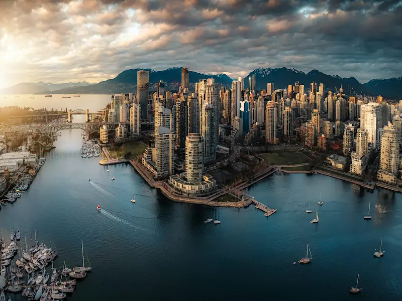 Panoramic view of Vancouver city skyline with ocean and mountains in the background